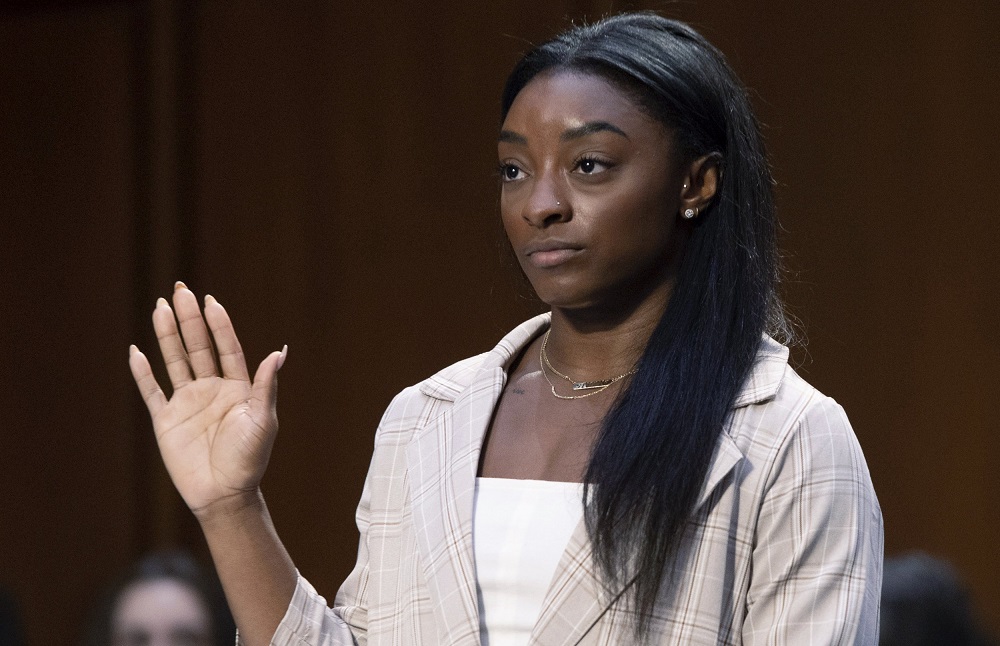 United States Olympic gymnast Simone Biles is sworn in during a Senate Judiciary hearing about the Inspector General's report on the FBI's handling of the Larry Nassar investigation on Capitol Hill, Wednesday, Sept. 15, 2021, in Washington. Nassar was charged in 2016 with federal child pornography offenses and sexual abuse charges in Michigan. He is now serving decades in prison after hundreds of girls and women said he sexually abused them under the guise of medical treatment when he worked for Michigan State and Indiana-based USA Gymnastics, which trains Olympians. (Saul Loeb/Pool via AP)